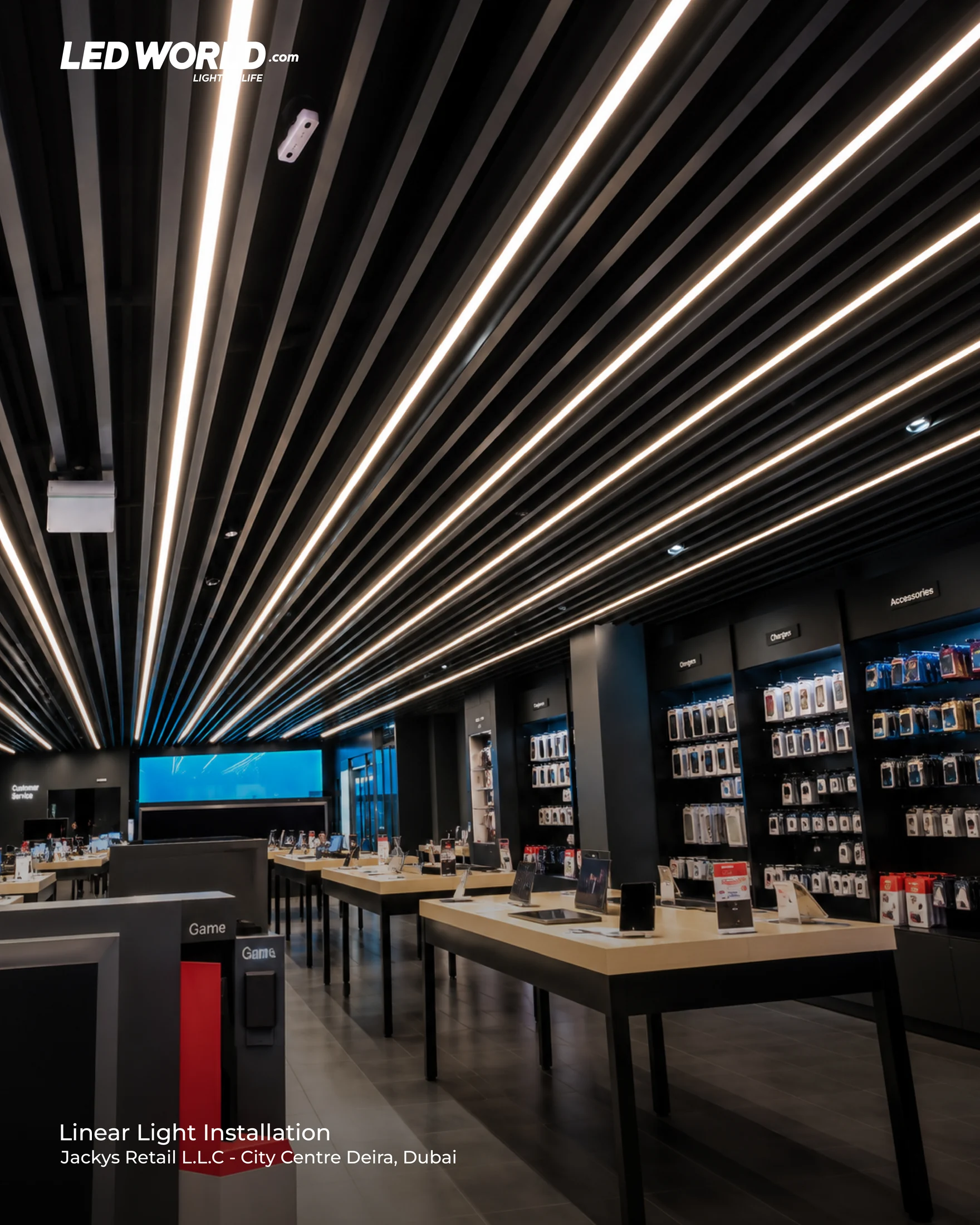 Parallel linear ceiling lights above electronics displays at Jacky's Retail, City Centre Deira