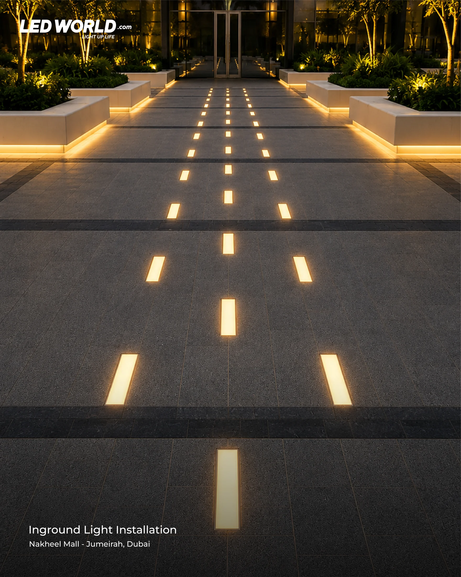 Evening view of rectangular inground lights along a paved pathway at Nakheel Mall, Dubai